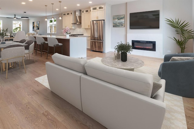 7431 W Forest Preserve Ave, Chicago, IL 60634 - living area with light wood finished floors, recessed lighting, and a glass covered fireplace