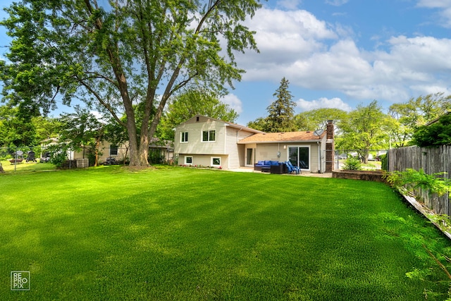 337 E Briarcliff Rd, Bolingbrook, IL 60440 - rear view of house with a fenced backyard, a chimney, and a patio