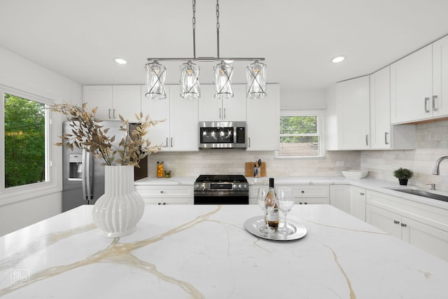 337 E Briarcliff Rd, Bolingbrook, IL 60440 - kitchen with stainless steel appliances, healthy amount of natural light, white cabinetry, backsplash, and recessed lighting
