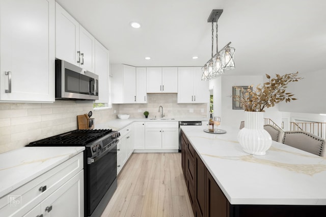 337 E Briarcliff Rd, Bolingbrook, IL 60440 - kitchen with appliances with stainless steel finishes, a center island, recessed lighting, light wood-style floors, and backsplash