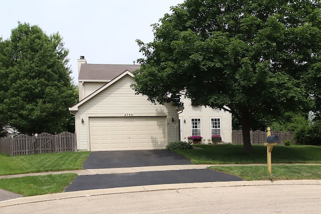 2799 Squaw Valley Trl, Aurora, IL 60503 - view of front of house with asphalt driveway, a garage, and a chimney