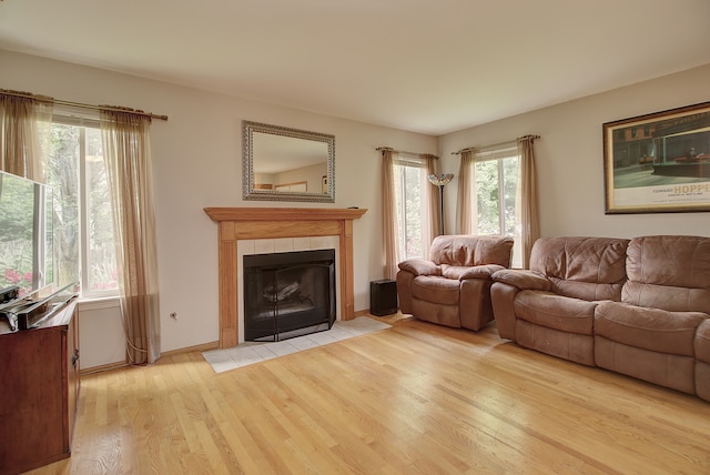 2799 Squaw Valley Trl, Aurora, IL 60503 - living area featuring light wood-style floors and a tiled fireplace