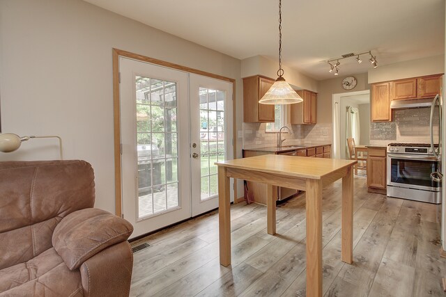 2799 Squaw Valley Trl, Aurora, IL 60503 - kitchen featuring gas range, open floor plan, french doors, backsplash, and under cabinet range hood