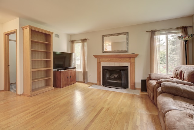 2799 Squaw Valley Trl, Aurora, IL 60503 - living area featuring light wood-style floors, plenty of natural light, and a tile fireplace