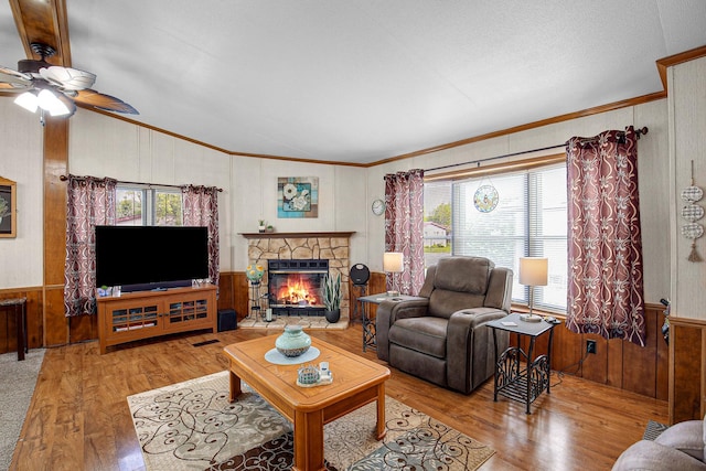 1178 Barry Ln, Sauk Village, IL 60411 - living room featuring vaulted ceiling, wood walls, wood finished floors, a ceiling fan, and ornamental molding