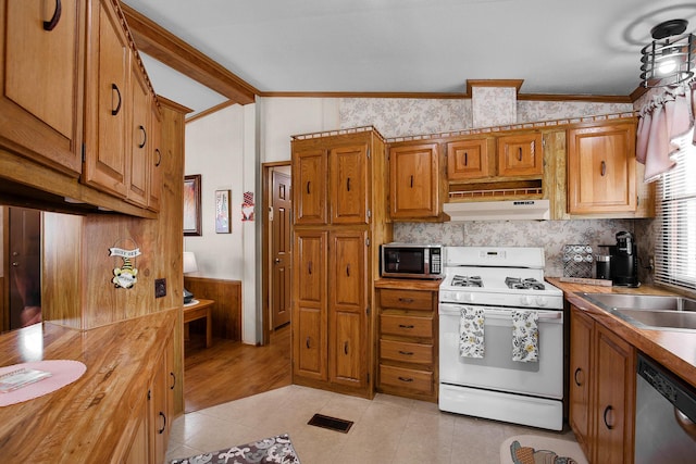 1178 Barry Ln, Sauk Village, IL 60411 - kitchen featuring stainless steel appliances, under cabinet range hood, crown molding, brown cabinetry, and light tile patterned floors
