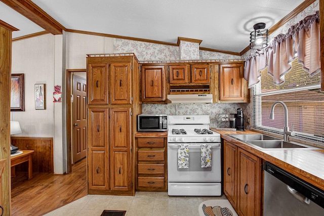 1178 Barry Ln, Sauk Village, IL 60411 - kitchen featuring appliances with stainless steel finishes, vaulted ceiling, under cabinet range hood, brown cabinetry, and crown molding