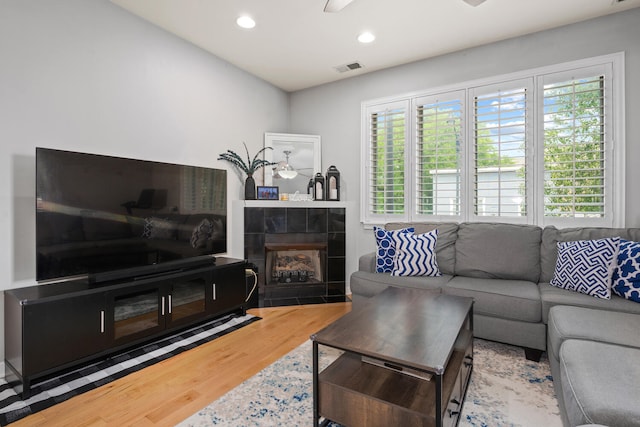 3021 W Armitage Ave Unit 201, Chicago, IL 60647 - living area featuring wood finished floors, healthy amount of natural light, a tile fireplace, and recessed lighting
