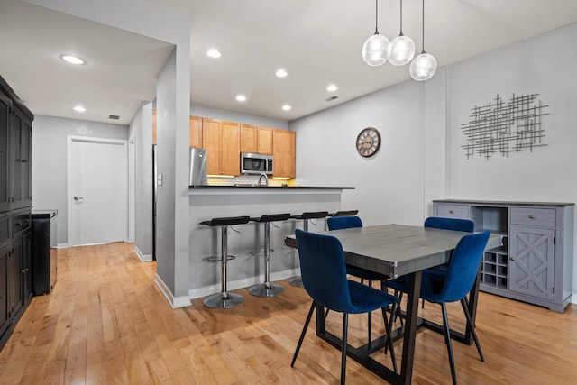 3021 W Armitage Ave Unit 201, Chicago, IL 60647 - dining space with light wood-style floors and recessed lighting