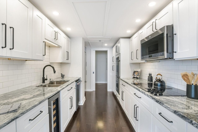 161 E Chicago Ave Unit 49B, Chicago, IL 60611 - kitchen with appliances with stainless steel finishes, beverage cooler, dark wood-style flooring, white cabinetry, and tasteful backsplash