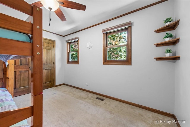 42W412 Sylvan Ln, Saint Charles, IL 60175 - unfurnished bedroom featuring light carpet, ornamental molding, and a ceiling fan