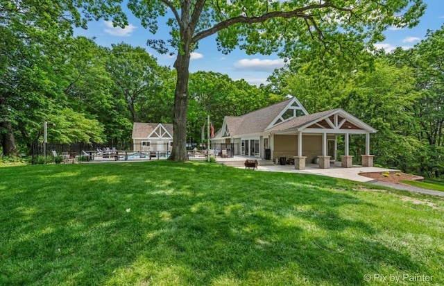 42W412 Sylvan Ln, Saint Charles, IL 60175 - rear view of house with a patio area, a swimming pool, view of scattered trees, and a fire pit