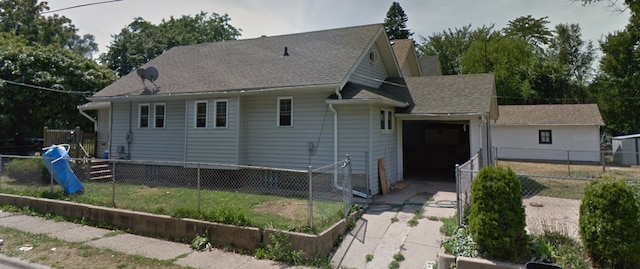 1319 Fairview Ave, Rockford, IL 61101 - back of property featuring an attached garage, driveway, and roof with shingles