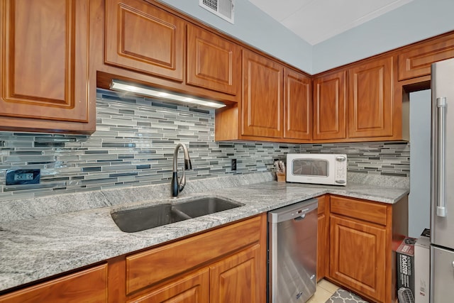 9535 S Mayfield Ave Unit 203, Oak Lawn, IL 60453 - kitchen featuring stainless steel dishwasher, white microwave, light stone counters, and brown cabinets