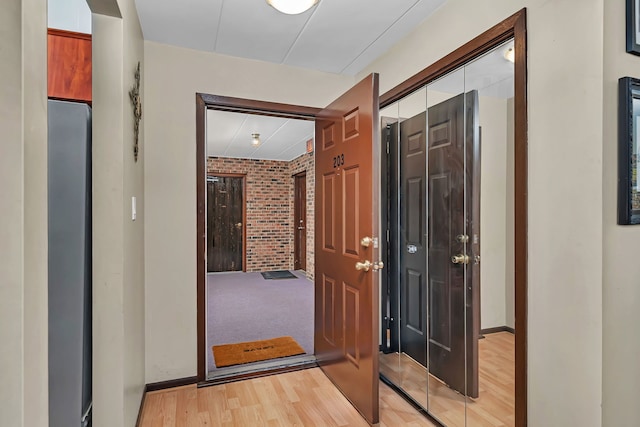 9535 S Mayfield Ave Unit 203, Oak Lawn, IL 60453 - hallway with brick wall and light wood finished floors