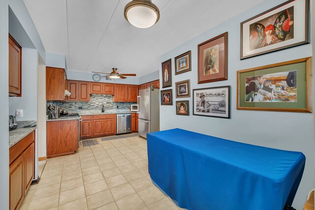 9535 S Mayfield Ave Unit 203, Oak Lawn, IL 60453 - kitchen with appliances with stainless steel finishes, a ceiling fan, brown cabinetry, tasteful backsplash, and light tile patterned floors