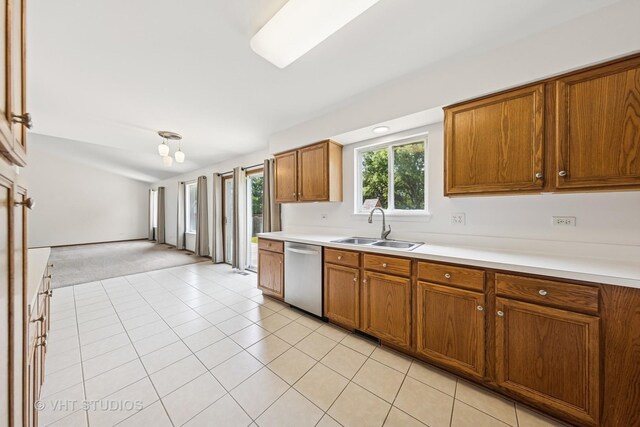 2664 Stuart Kaplan Dr, Aurora, IL 60503 - kitchen with dishwasher, brown cabinets, light countertops, and plenty of natural light