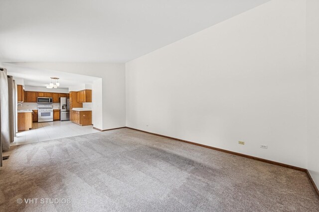 2664 Stuart Kaplan Dr, Aurora, IL 60503 - spare room with light carpet, plenty of natural light, and lofted ceiling