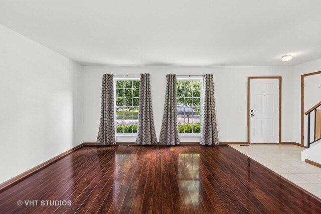 2664 Stuart Kaplan Dr, Aurora, IL 60503 - unfurnished living room with stairway and light wood-style floors