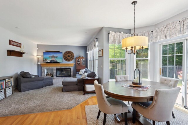18485 W Springwood Dr, Grayslake, IL 60030 - dining room with a chandelier, light wood-style floors, and a fireplace