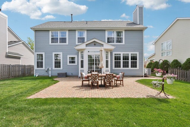18485 W Springwood Dr, Grayslake, IL 60030 - rear view of property featuring a fenced backyard, a patio area, and a chimney