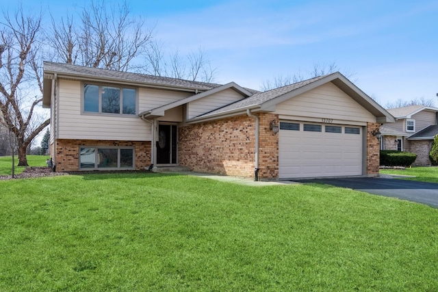 13707 W Carefree Dr, Homer Glen, IL 60491 - tri-level home featuring a front lawn, a garage, driveway, and brick siding