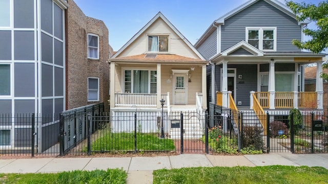4036 N Bernard St, Chicago, IL 60618 - view of front of home featuring covered porch, a fenced front yard, and a gate