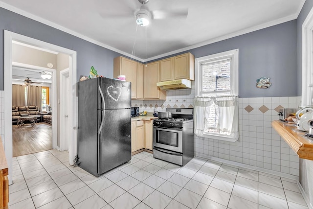 4036 N Bernard St, Chicago, IL 60618 - kitchen featuring freestanding refrigerator, stainless steel gas range oven, ceiling fan, under cabinet range hood, and light brown cabinets