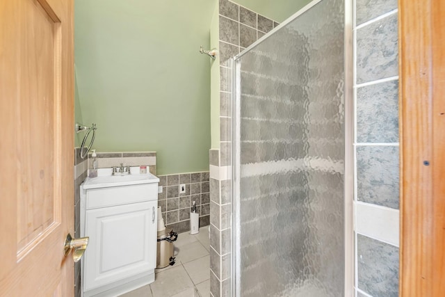 4036 N Bernard St, Chicago, IL 60618 - bathroom featuring tile walls, a shower stall, tile patterned flooring, vanity, and wainscoting