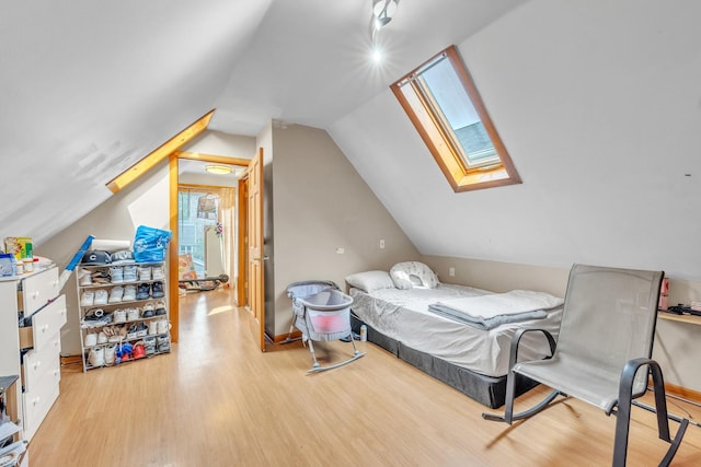4036 N Bernard St, Chicago, IL 60618 - bedroom with wood finished floors, a skylight, and vaulted ceiling