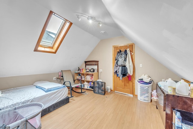 4036 N Bernard St, Chicago, IL 60618 - bedroom with wood finished floors, vaulted ceiling, and a skylight