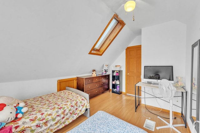 4036 N Bernard St, Chicago, IL 60618 - bedroom featuring lofted ceiling, a skylight, light wood-style flooring, and ceiling fan