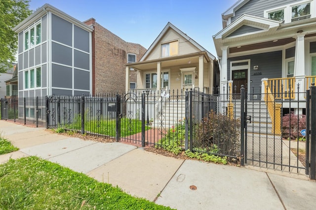4036 N Bernard St, Chicago, IL 60618 - view of front of home featuring covered porch, a gate, and a fenced front yard