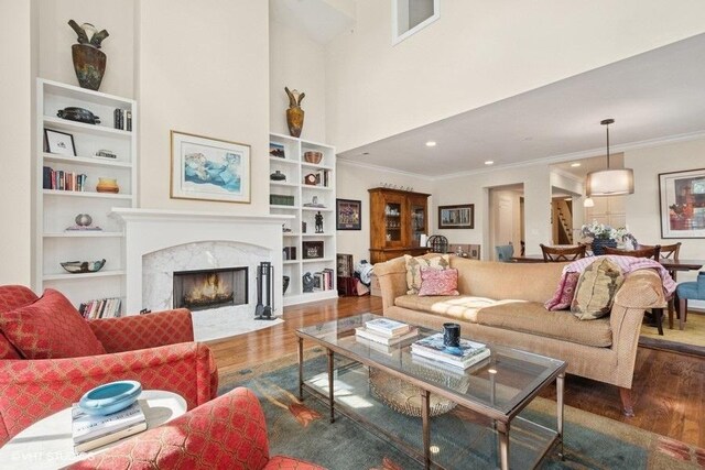2642 Prairie Ave Unit 2, Evanston, IL 60201 - living area with wood finished floors, ornamental molding, built in shelves, a high end fireplace, and recessed lighting
