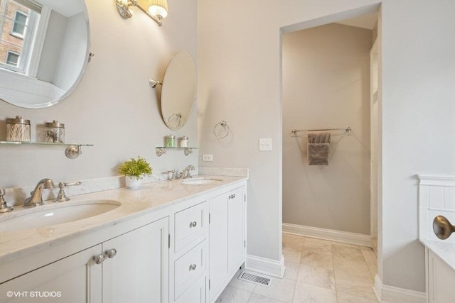 2642 Prairie Ave Unit 2, Evanston, IL 60201 - bathroom featuring double vanity and baseboards