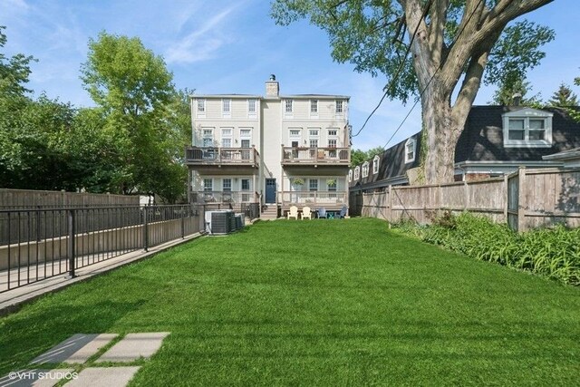 2642 Prairie Ave Unit 2, Evanston, IL 60201 - back of house featuring a fenced backyard and a chimney