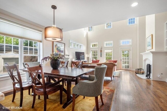 2642 Prairie Ave Unit 2, Evanston, IL 60201 - dining room featuring wood finished floors, a fireplace with flush hearth, and recessed lighting