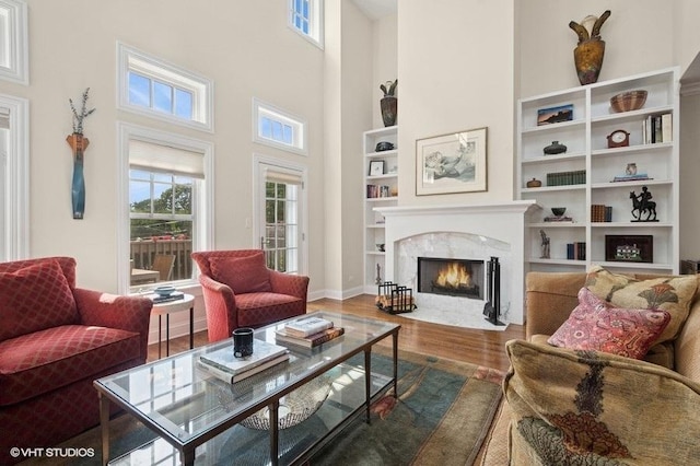 2642 Prairie Ave Unit 2, Evanston, IL 60201 - living area with a fireplace, wood finished floors, a towering ceiling, and built in shelves