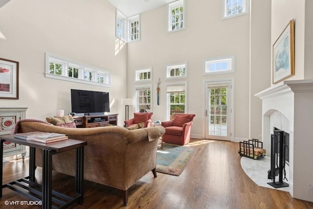 2642 Prairie Ave Unit 2, Evanston, IL 60201 - living area featuring a towering ceiling, a fireplace with flush hearth, and wood finished floors