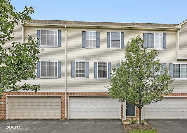 1944 Indian Hill Ln, Aurora, IL 60503 - townhome / multi-family property with asphalt driveway, an attached garage, and brick siding