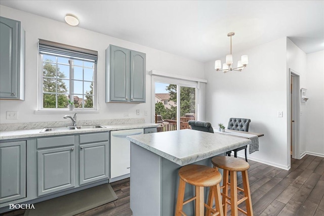 1944 Indian Hill Ln, Aurora, IL 60503 - kitchen with dishwasher, dark wood-style floors, a chandelier, a kitchen bar, and light countertops