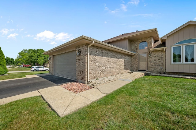 7749 W Lakeview Ter, Frankfort, IL 60423 - view of side of home featuring a lawn, a garage, brick siding, and asphalt driveway