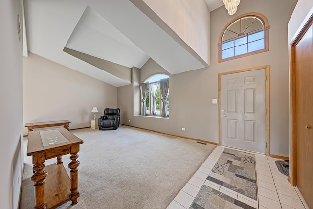7749 W Lakeview Ter, Frankfort, IL 60423 - foyer entrance with light tile patterned floors, a high ceiling, light carpet, and a chandelier