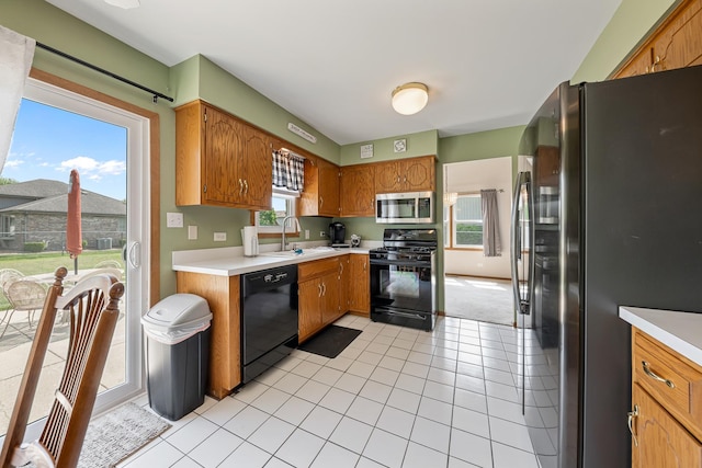 7749 W Lakeview Ter, Frankfort, IL 60423 - kitchen with black appliances, light countertops, brown cabinets, and light tile patterned flooring