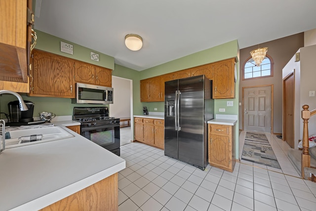 7749 W Lakeview Ter, Frankfort, IL 60423 - kitchen featuring stainless steel microwave, refrigerator with ice dispenser, black gas range oven, light countertops, and light tile patterned floors