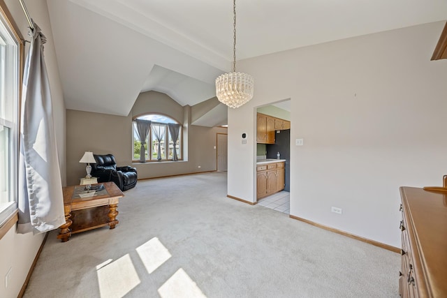 7749 W Lakeview Ter, Frankfort, IL 60423 - living area featuring light colored carpet, a chandelier, and vaulted ceiling