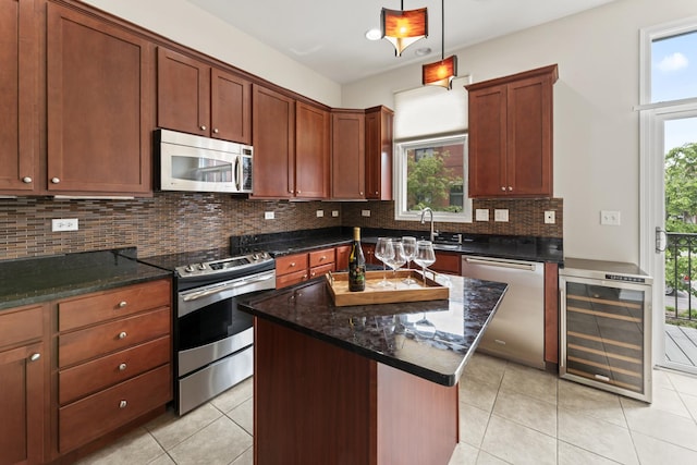 319 W Wood St Unit 18, Palatine, IL 60067 - kitchen featuring appliances with stainless steel finishes, beverage cooler, plenty of natural light, and backsplash
