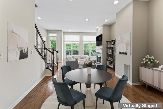 319 W Wood St Unit 18, Palatine, IL 60067 - dining space featuring a high end fireplace, wood finished floors, stairs, and recessed lighting
