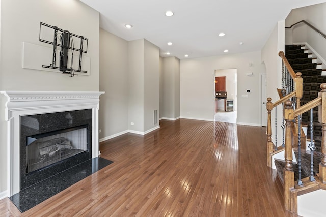 319 W Wood St Unit 18, Palatine, IL 60067 - unfurnished living room featuring stairway, wood-type flooring, a high end fireplace, and recessed lighting