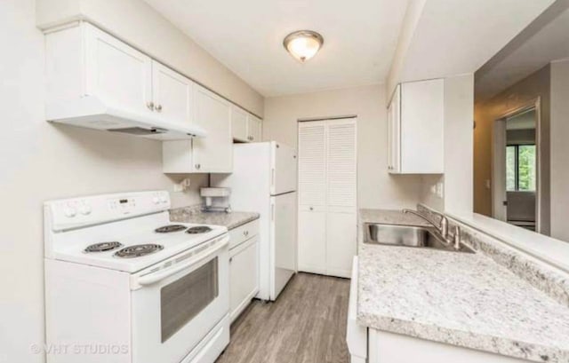 633 Virginia Rd Unit 214, Crystal Lake, IL 60014 - kitchen with white appliances, under cabinet range hood, light countertops, white cabinetry, and light wood-style floors